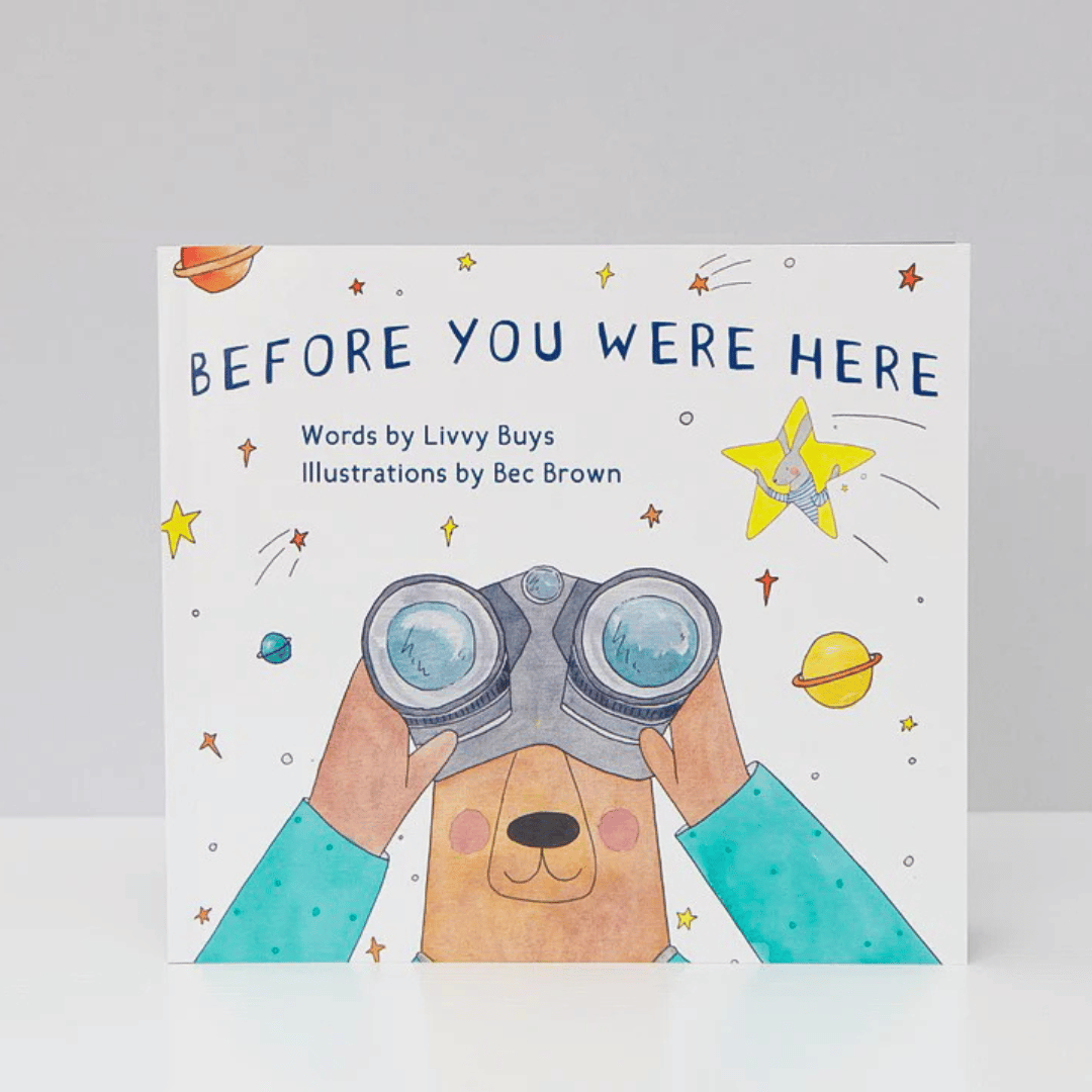 Book cover of 'Before You Were Here' with a bear holding binoculars and space-themed illustrations.