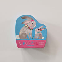 Puzzle box with rabbit illustration on a light gray background