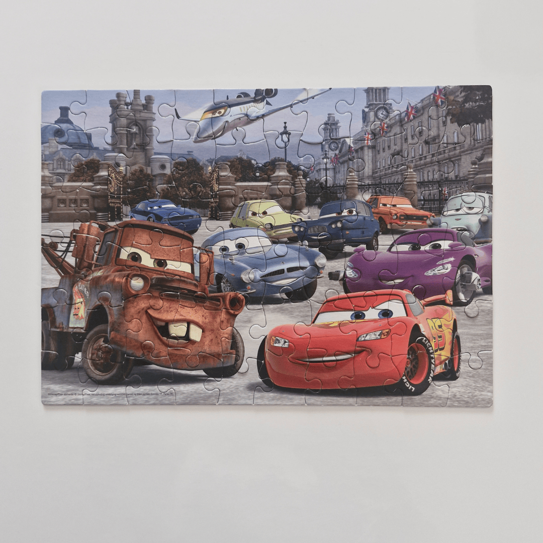 Puzzle with cartoon cars and a helicopter on a city street background