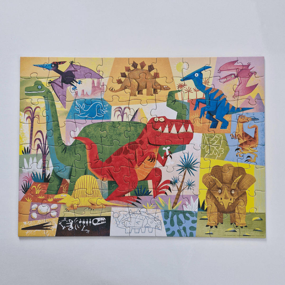 Children's dinosaur puzzle with colorful pieces on a light gray background