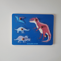 Dinosaur-themed puzzle with clear pieces on a blue base, featuring the brand 'Crocodile Creek'.
