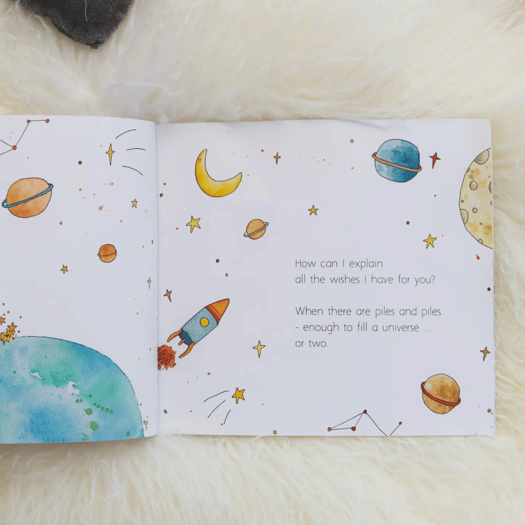 Open book with space-themed illustrations and text on a soft surface