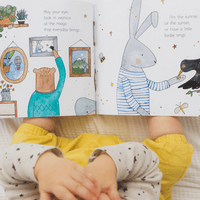 Children's book open to pages with illustrations of a bear, rabbit, and bird.