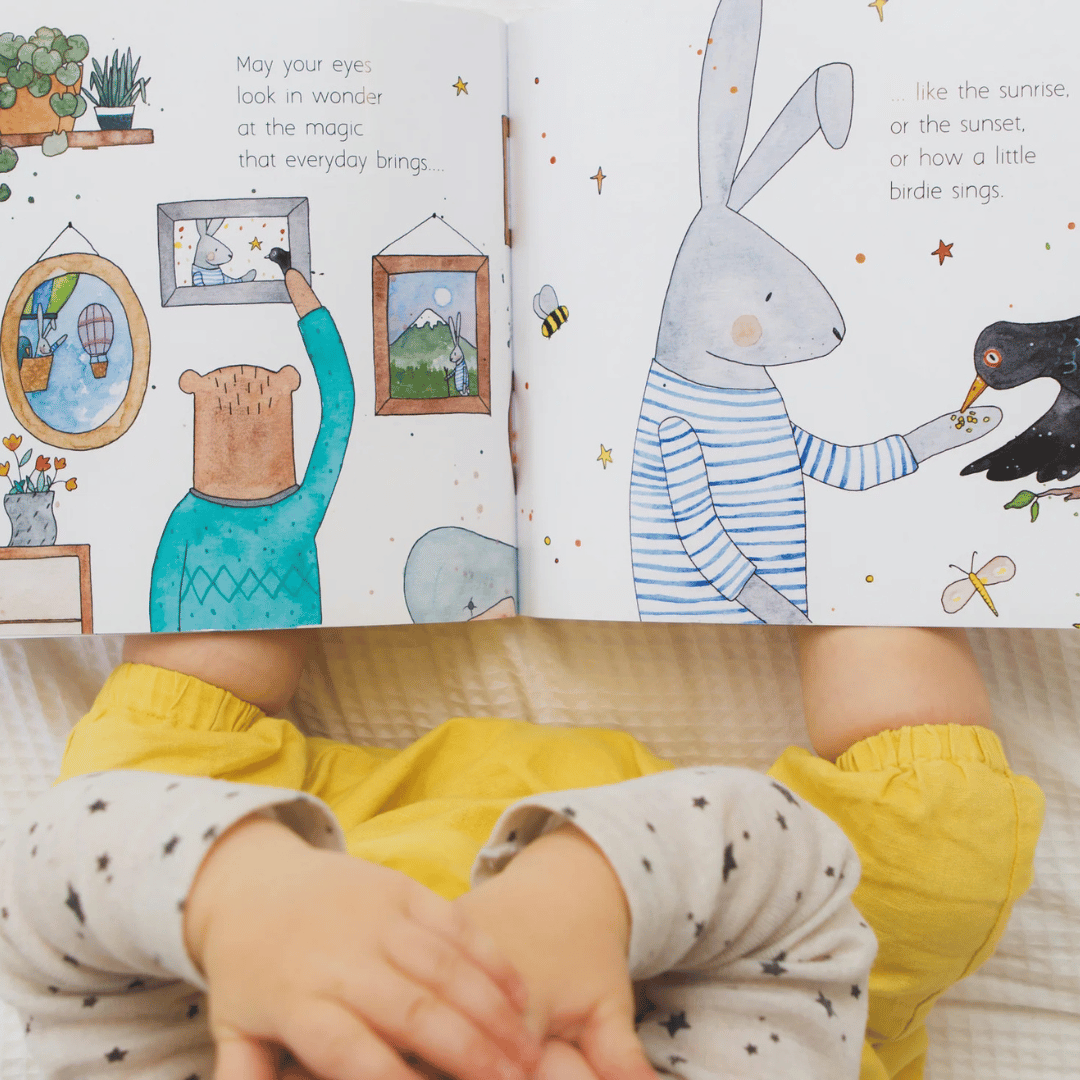 Children's book open to pages with illustrations of a bear, rabbit, and bird.