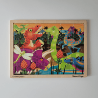Colorful dinosaur-themed wooden puzzle on a white background