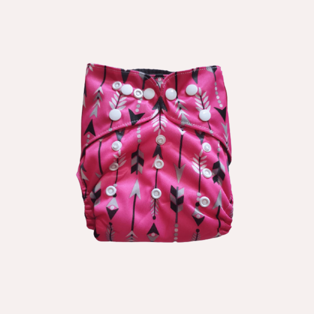 Pink reusable cloth nappy with black and white pattern on a light grey background