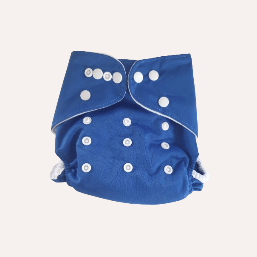 Blue cloth reusable nappy with white buttons on a light grey background