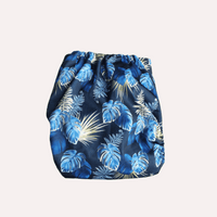 Blue tropical leaf patterned reusable cloth nappy on a white background