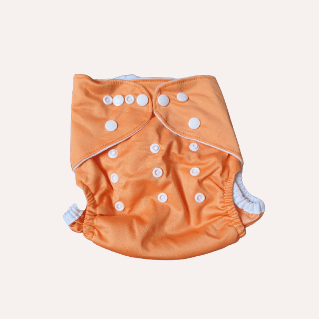 Orange reusable cloth nappy with white buttons on a light grey background