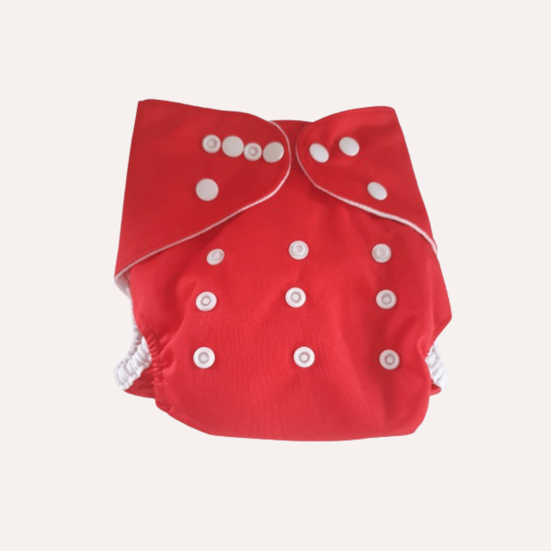 Red reusable cloth nappy with white buttons on a light grey background