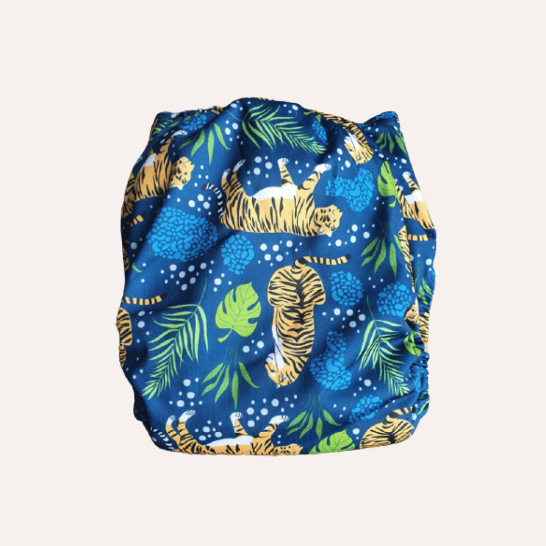 Blue reusable cloth nappy with tiger and leaf pattern on a white background