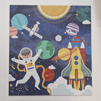 Children's puzzle with space-themed design including an astronaut, planets, and a rocket.