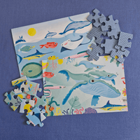 Children's puzzle with ocean-themed illustrations on a blue background