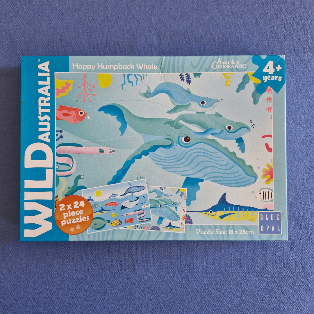 Puzzle box featuring whale illustrations on a blue background