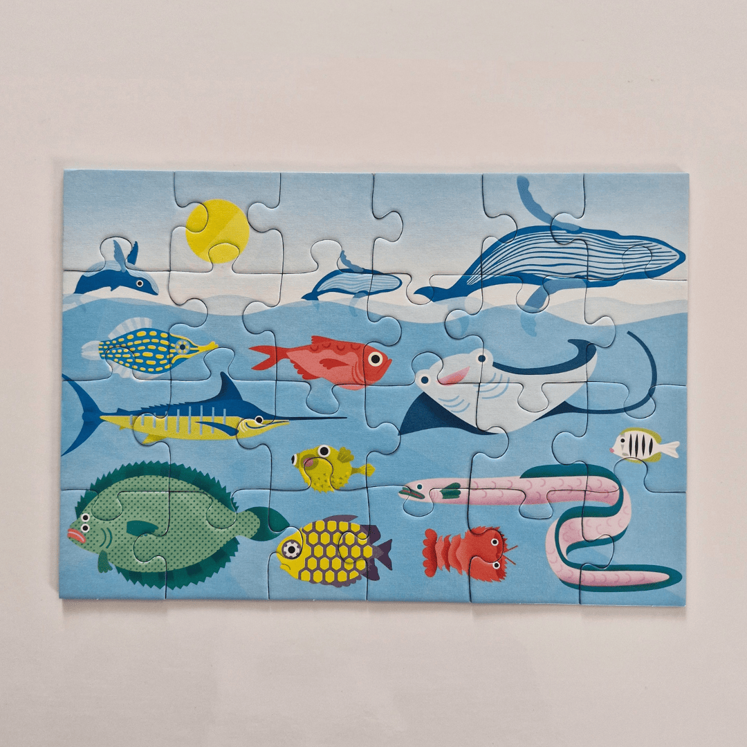 Children's puzzle with sea-themed illustrations on a light blue background