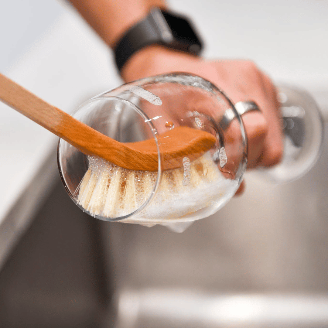 wooden dish brush washing a wine glass