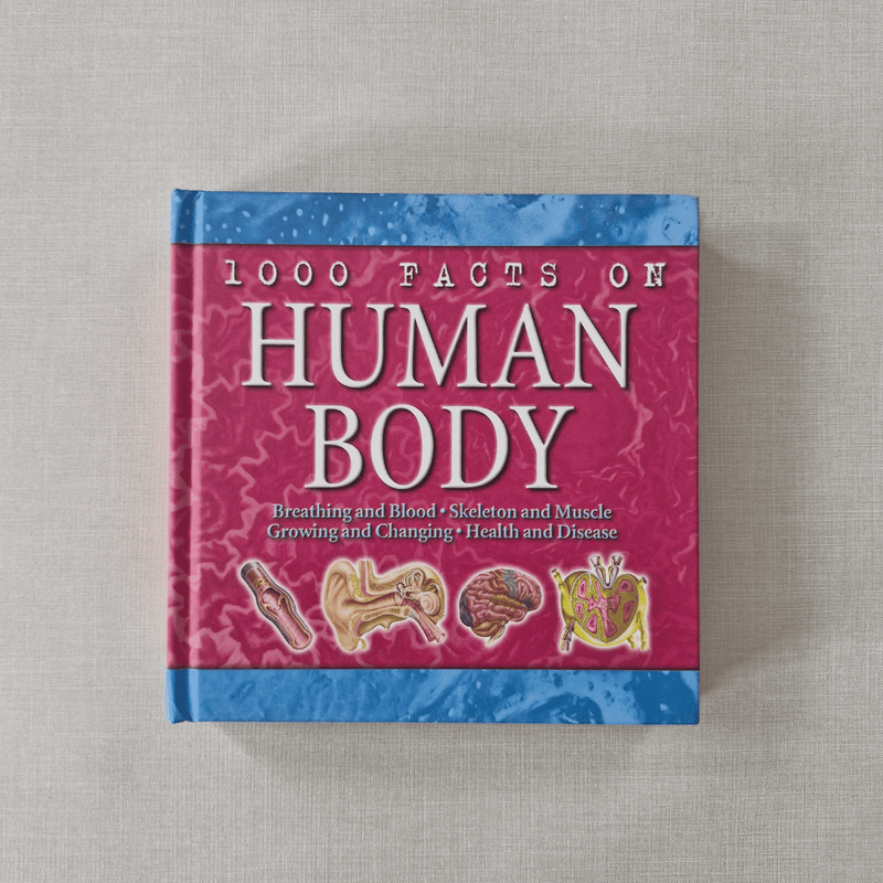 Book titled '1000 Facts on Human Body' on a textured surface
