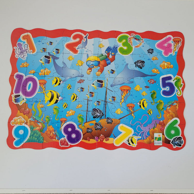 Colourful children's puzzle with sea-themed illustrations on a white background