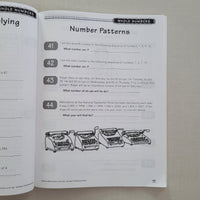 Open book showing a page with number patterns exercise on a textured surface