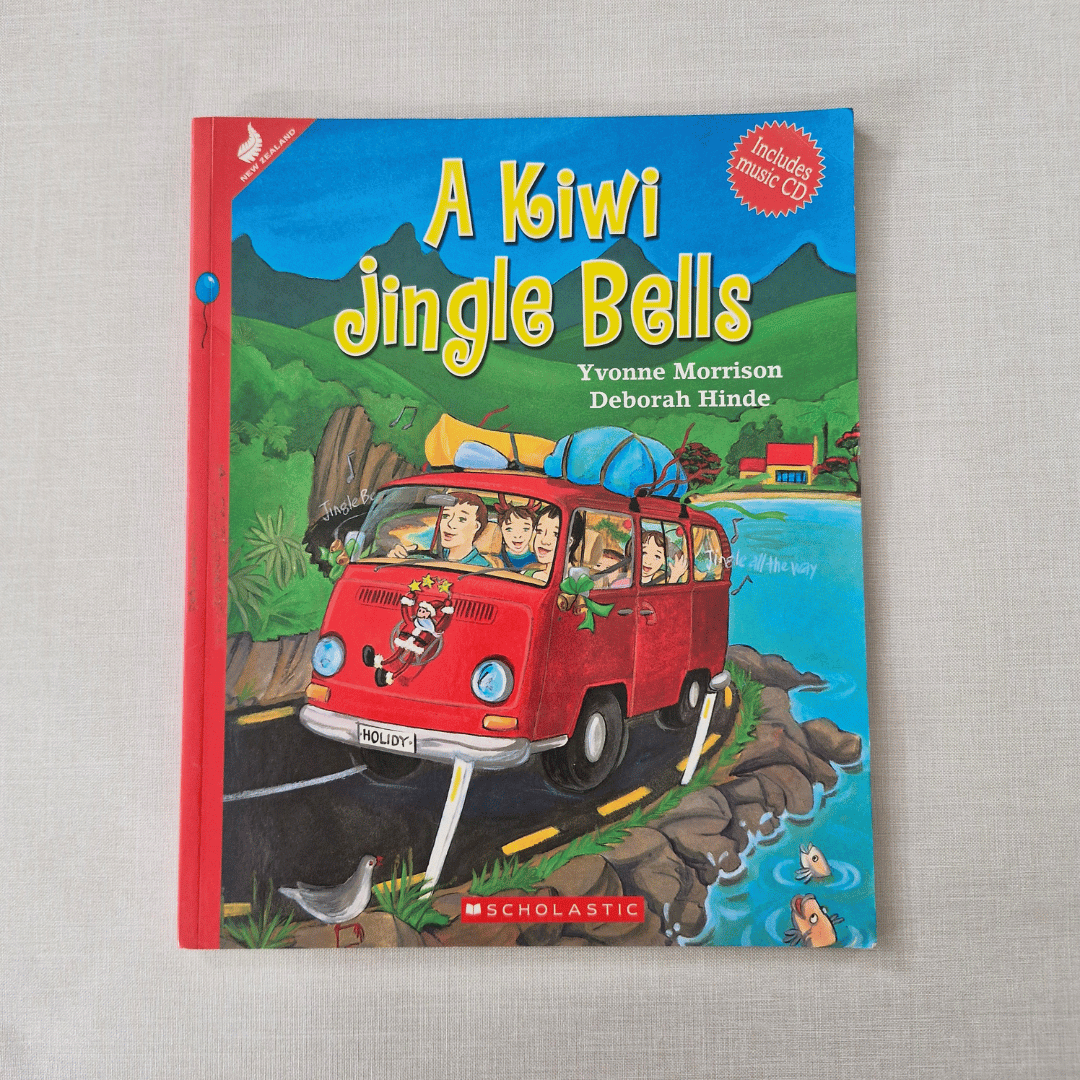 Book cover of 'A Kiwi Jingle Bells' with a red van and mountain landscape on a grey background