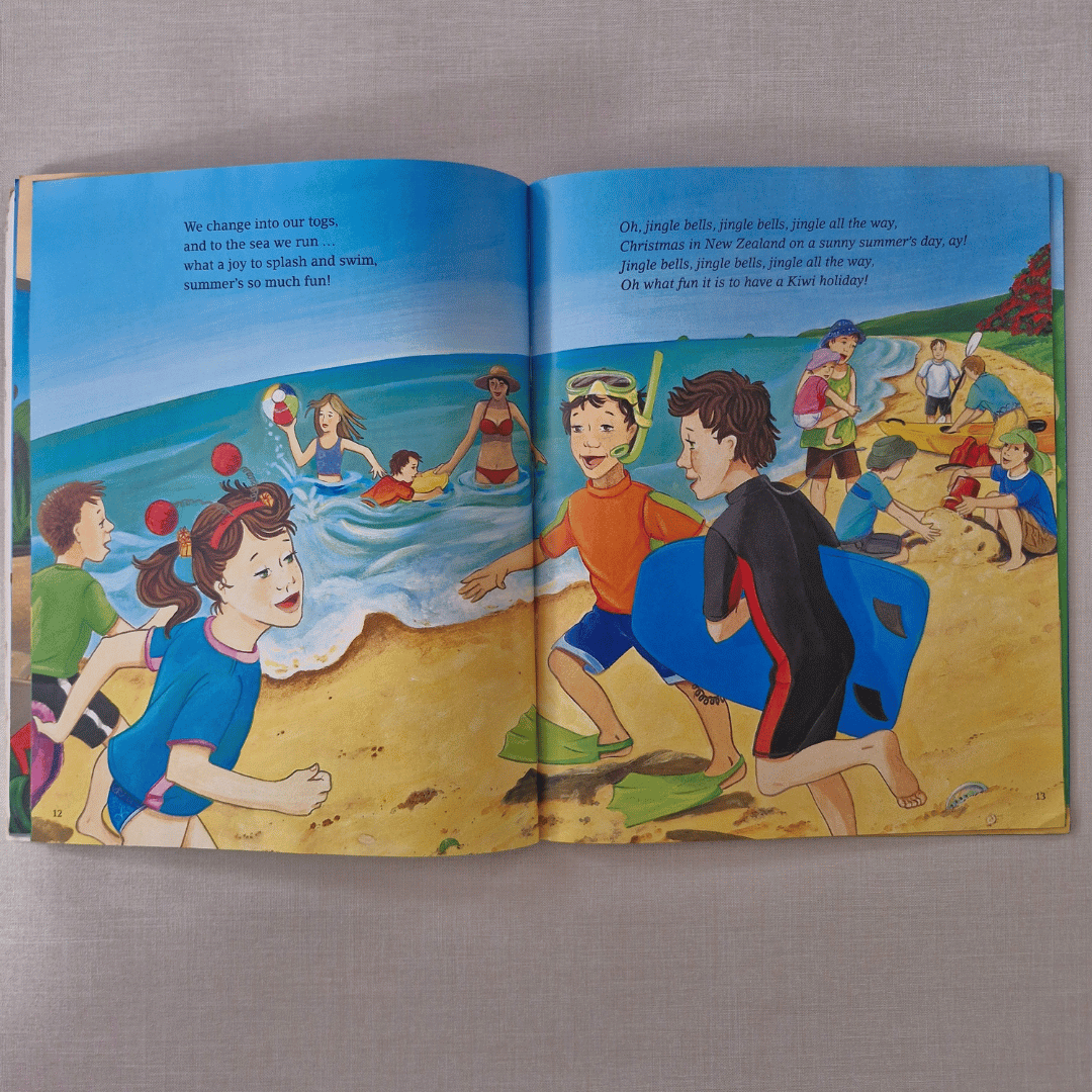 Open book showing a colourful illustration of children at the beach.