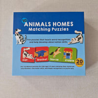 Box of '10 Animals Homes Matching Puzzles' on a textured surface