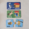 Three educational flashcards showing animals and their habitats on a textured surface.