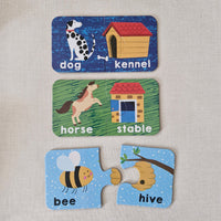 Three educational flashcards showing animals and their habitats on a textured surface.