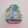 Animal shaped puzzle packaging with a giraffe, monkey, elephant, lion, and tree design on a white background.