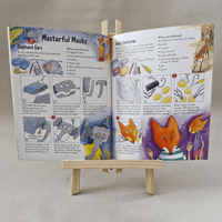Open book with instructions on making masks on a small wooden easel.