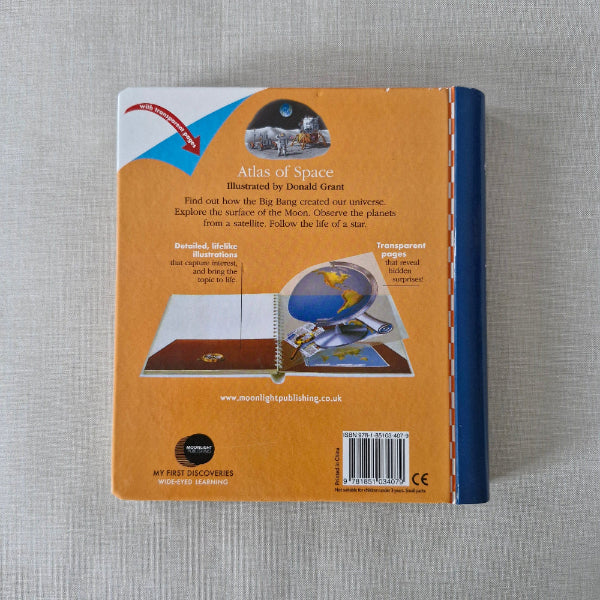 Back cover of a book with text and a barcode on a gray surface