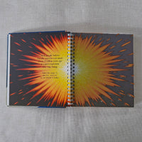 Notebook with a sunburst design on a gray fabric background