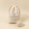 Wool dryer ball with drawstring bag labeled 'Babu' on a beige background