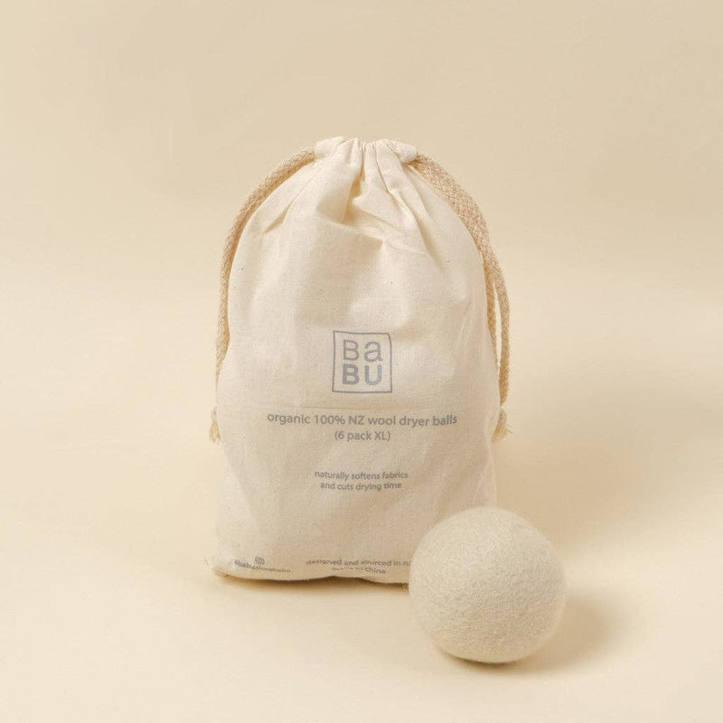 Wool dryer ball with drawstring bag labeled 'Babu' on a beige background