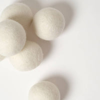 White wool dryer balls on a white background
