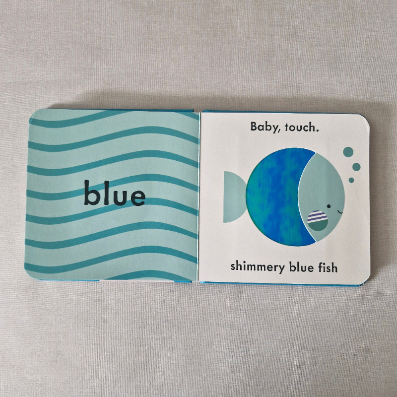 Children's book with a blue fish illustration on a gray background