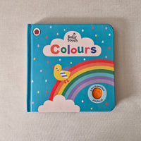Children's book titled 'Colours' by Baby Touch with a rainbow and duck illustration on a textured surface.