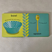 Children's book with illustrations of a spoon and bowl on a textured surface