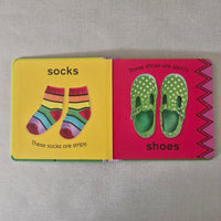Children's book with illustrations of shoes and socks on a pink and yellow background.