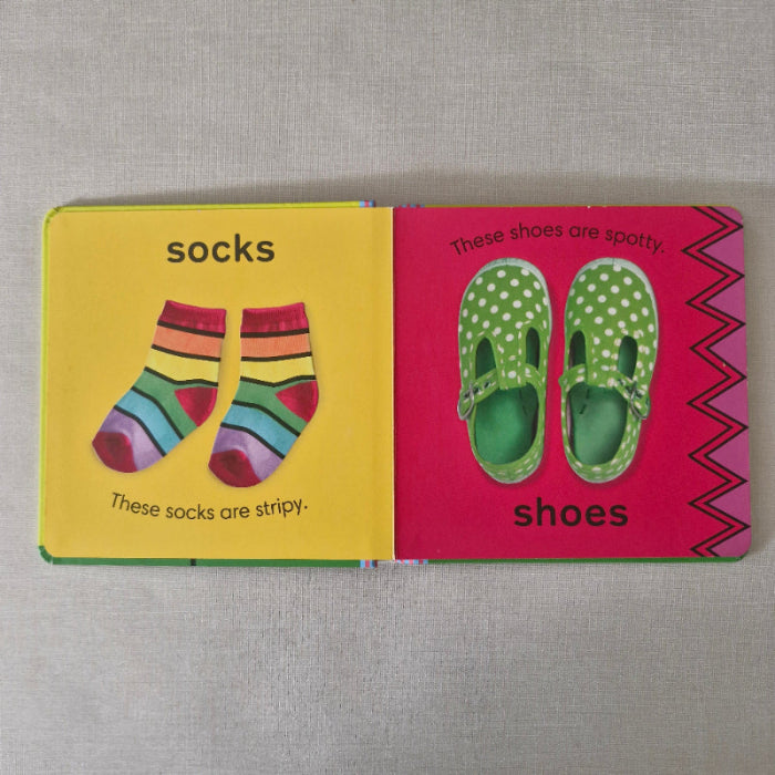Children's book with illustrations of shoes and socks on a pink and yellow background.