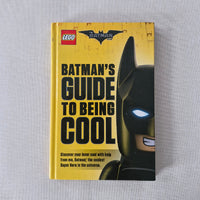 Book titled 'Batman's Guide to Being Cool' with a LEGO Batman logo on a gray background