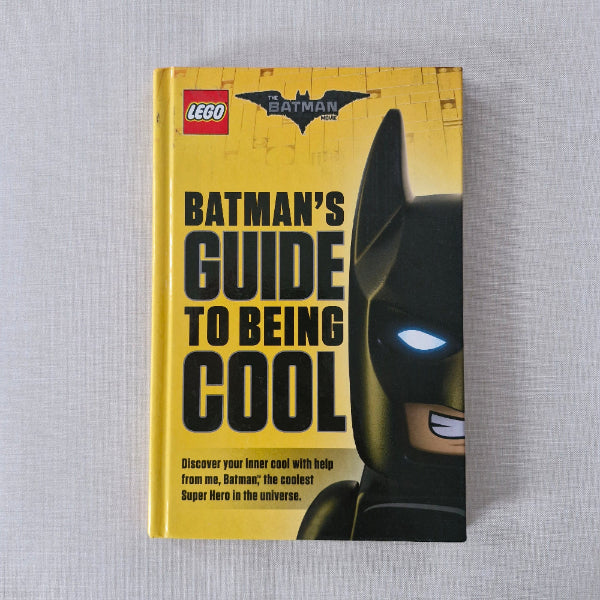 Book titled 'Batman's Guide to Being Cool' with a LEGO Batman logo on a gray background