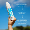 Hand holding a noody product with application instructions against a blue sky.