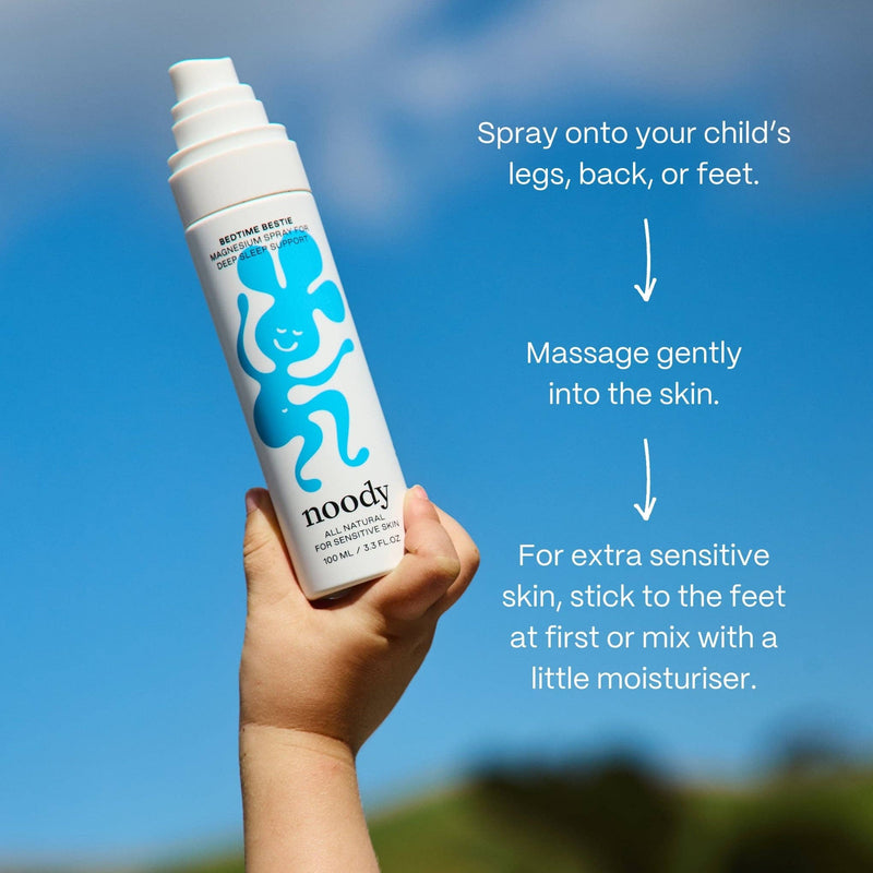 Hand holding a noody product with application instructions against a blue sky.