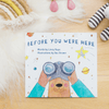 Children's book titled 'Before You Were Here' on a wooden surface with toys around