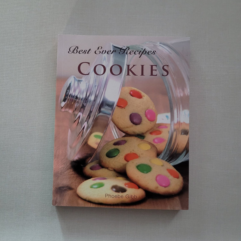 Cookbook cover with colourful cookies and a jar on a gray background