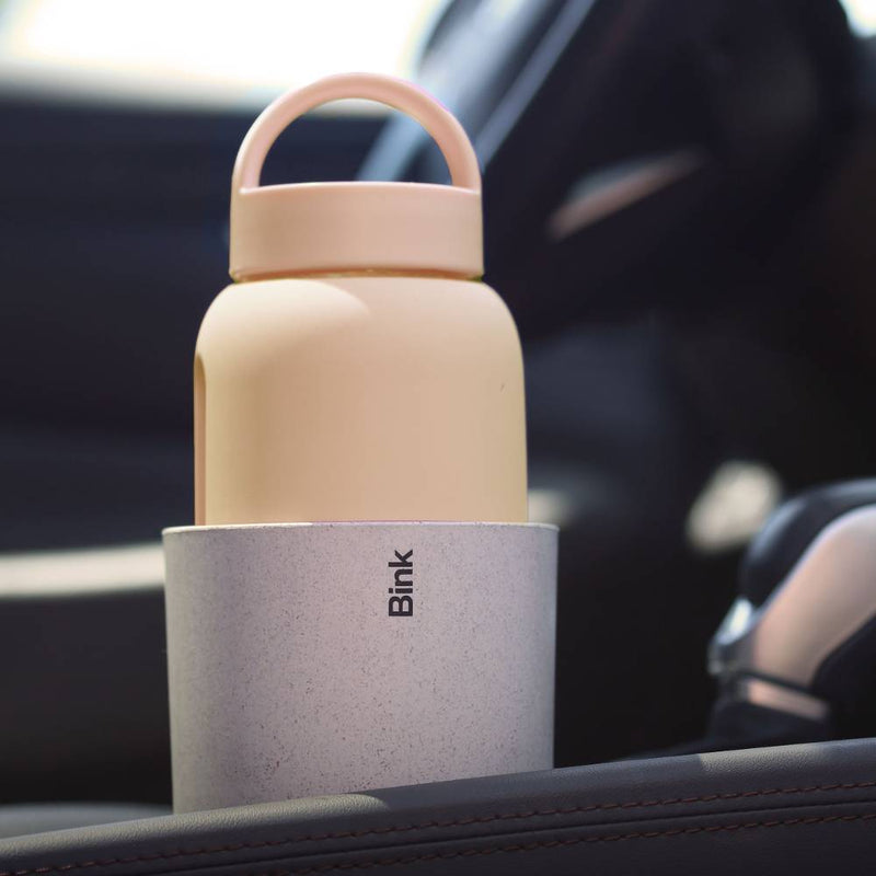 Blink water bottle holder with beige bottle inside a car.