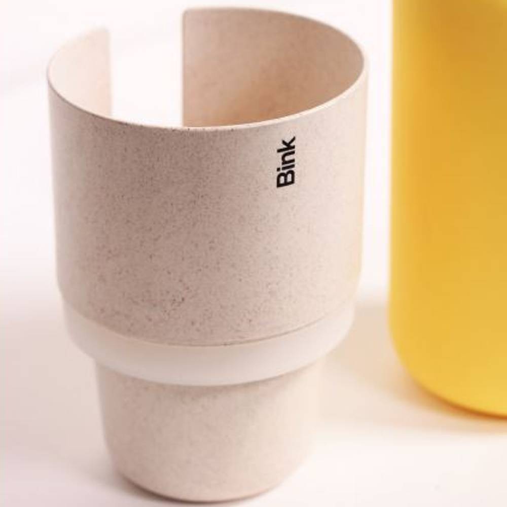 Straw  coloured cup holder with 'Bink' branding on a white background