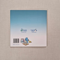 Back cover of a book with a gradient blue design and a barcode on a textured beige background
