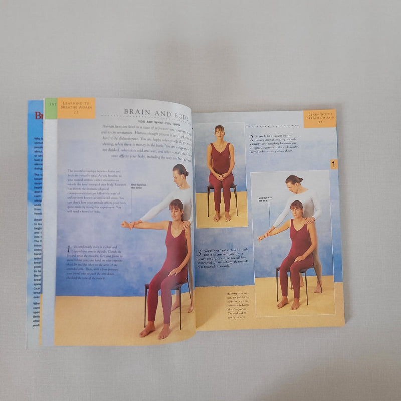 Open book with illustrations of a person in a red exercise clothes sitting on a chair
